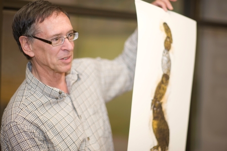 Dr. Bell showing a print under discussion.